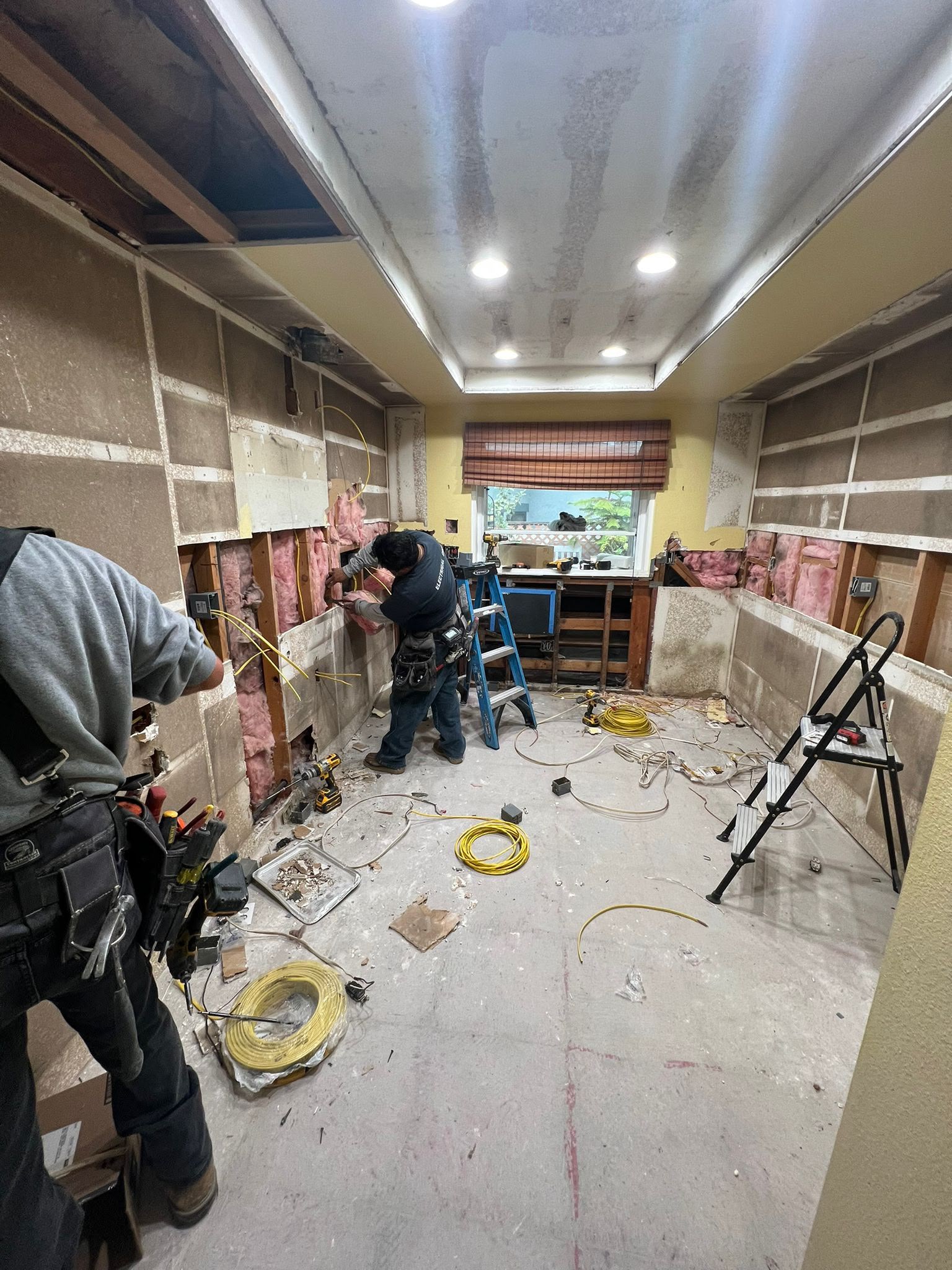 Azusa kitchen gutted, with the crew opening the walls before the new cabinets