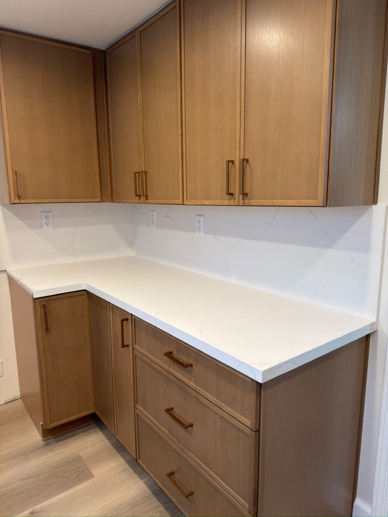 New white countertop and white oak cabinets in the Pasadena kitchen