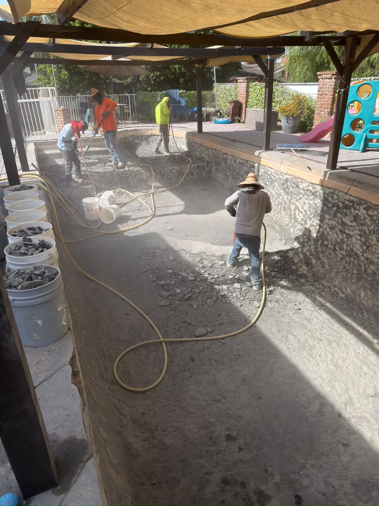 Old Whittier pool surface being washed off before the new finish