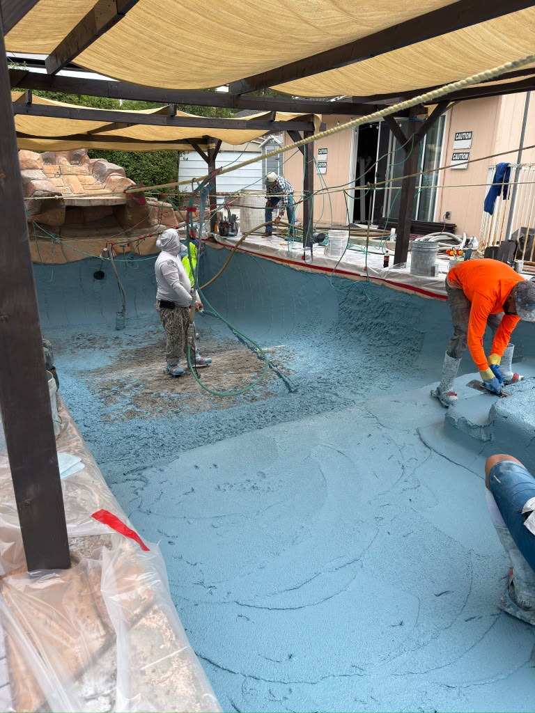 Crew installing the new mini pebble finish in the Whittier pool