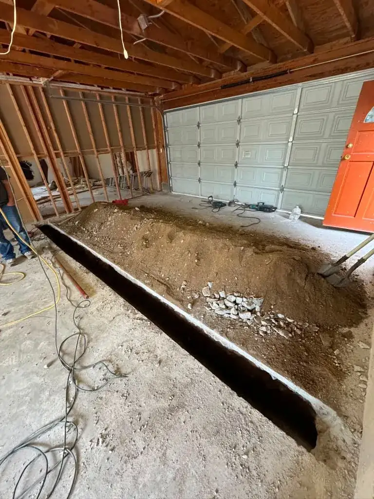 Trenching the garage slab for new footings and drain lines
