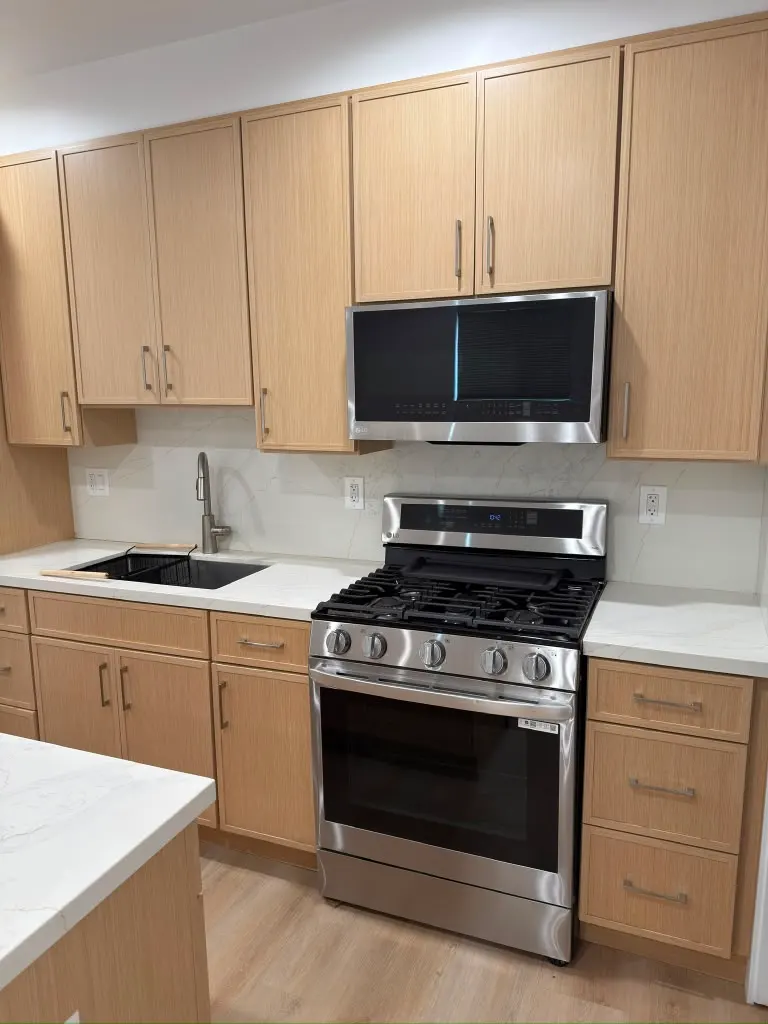 Finished ADU kitchen with quartz counters and stainless appliances