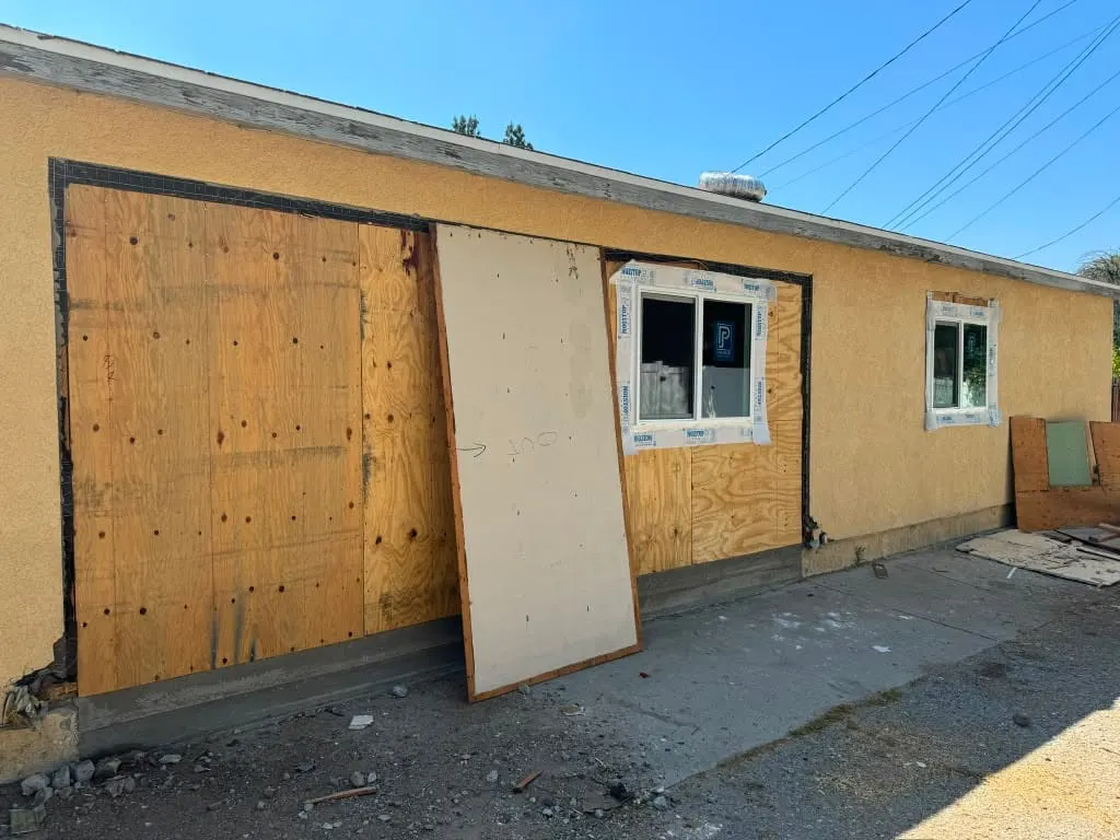 Encino garage mid-conversion with the garage door opening framed in